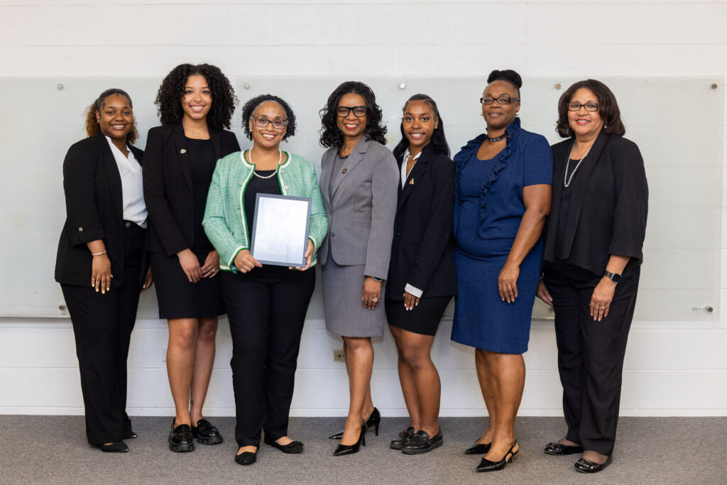 A photo of mentors and students standing side by side.