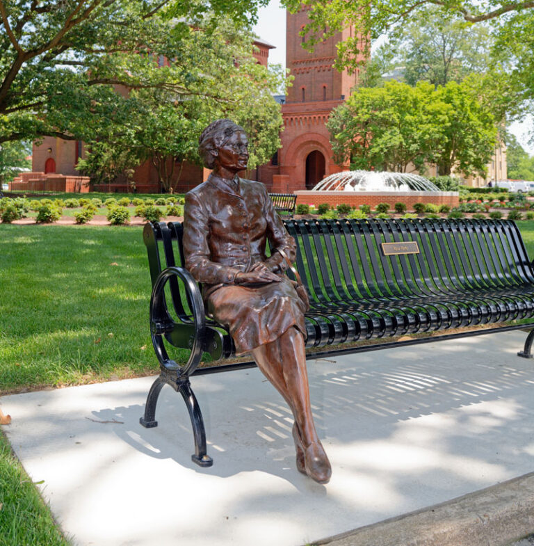 Photo of a statue of Rosa Parks sitting on a bench located in Legacy Park on Hampton's campus.