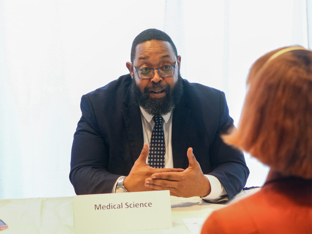 A photo of a professor discussing with a student.