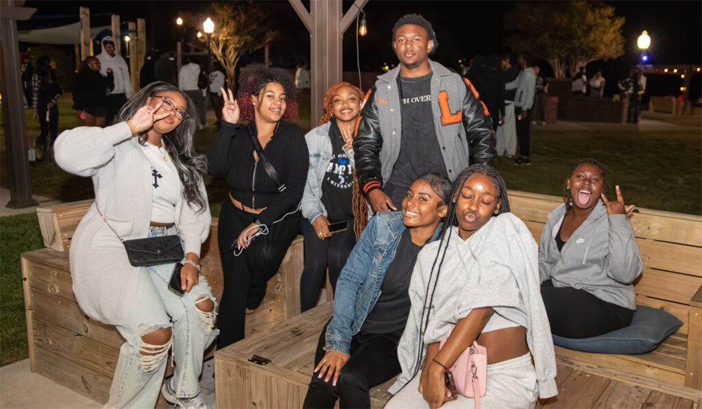 Photo of Students sitting outside at night.
