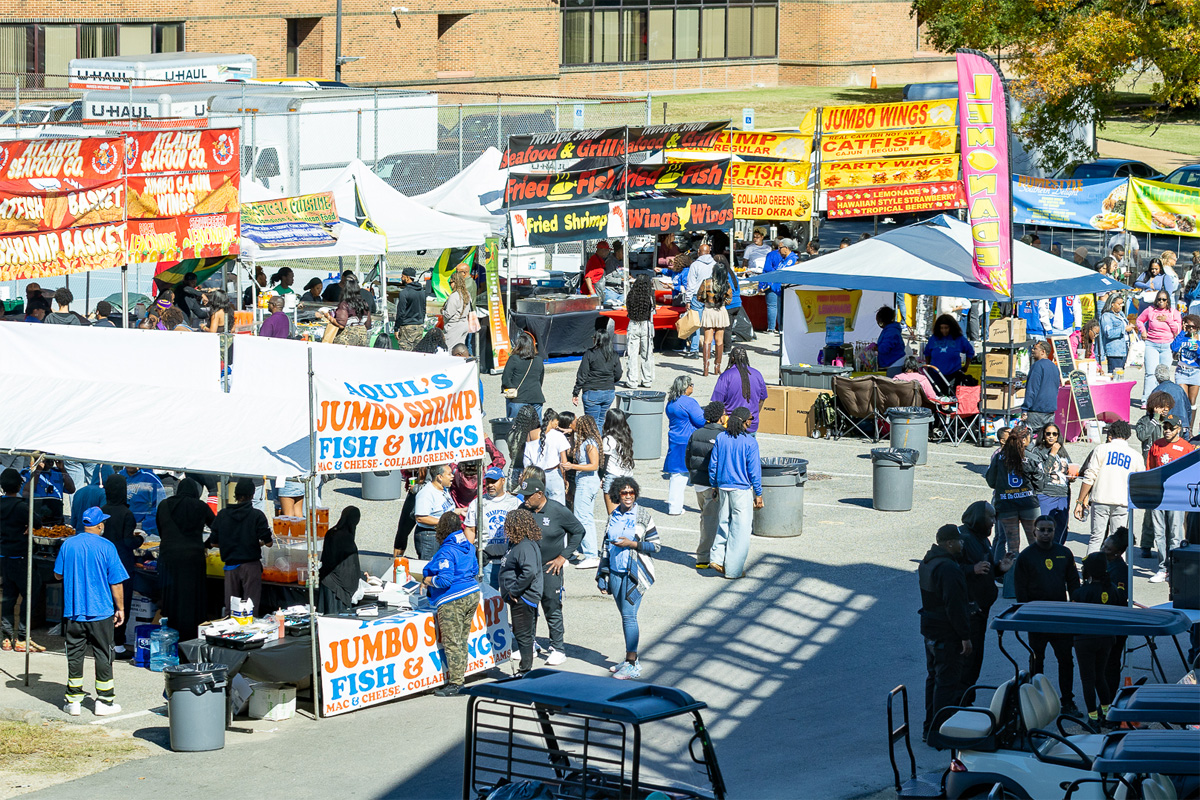 A photo of a large crowd and food vendor stalls.