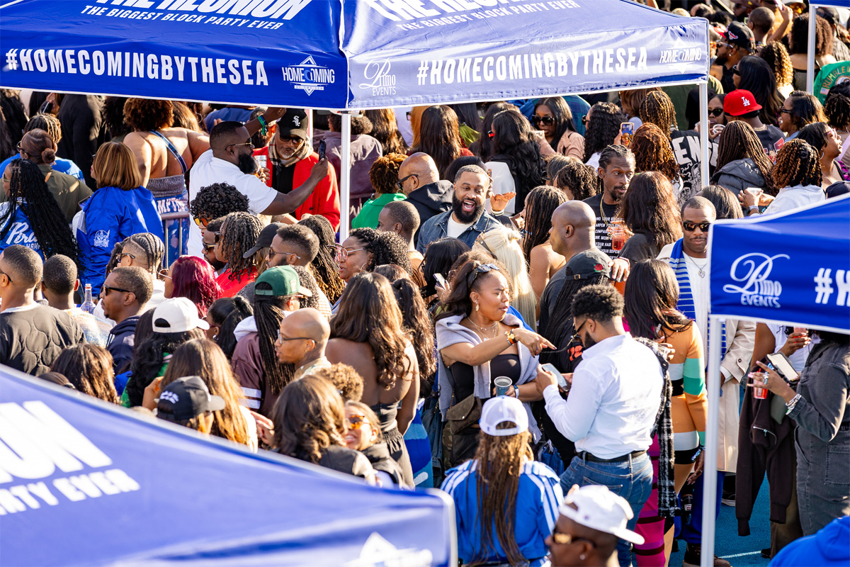 A photo of a crowd of attendees perusing through a selection of vendor booths.