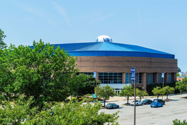 A photo showing the Convocation Center's large, blue roof and parking lot.