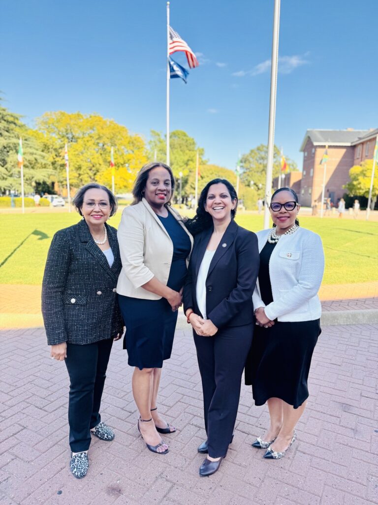 A photo of the four founding staff members of LEAD standing at Ogden Hall. Starting on the left, Dr. Denise Charbonnet, Dr. Jessica Sullivan, Dr. Neelam Azad, and Dr. Katina Ward-James.
