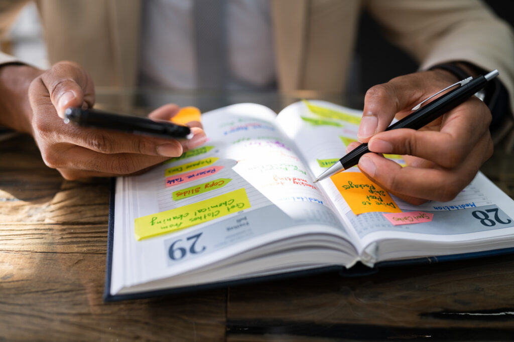 A photo of a person looking at a schedule planner book.