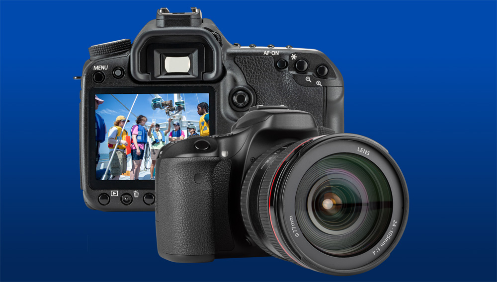 A graphic of a DSLR camera taking a photo of university students on a boat.