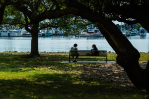 Hampton University students sitting by the waterfront on campus