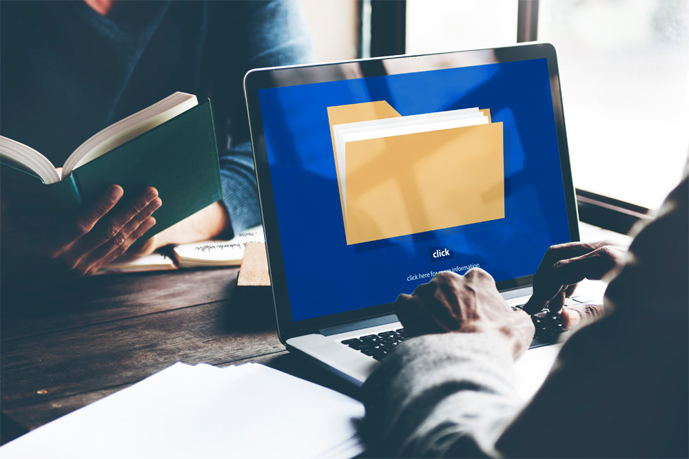 Photo of a laptop showing a folder icon.
