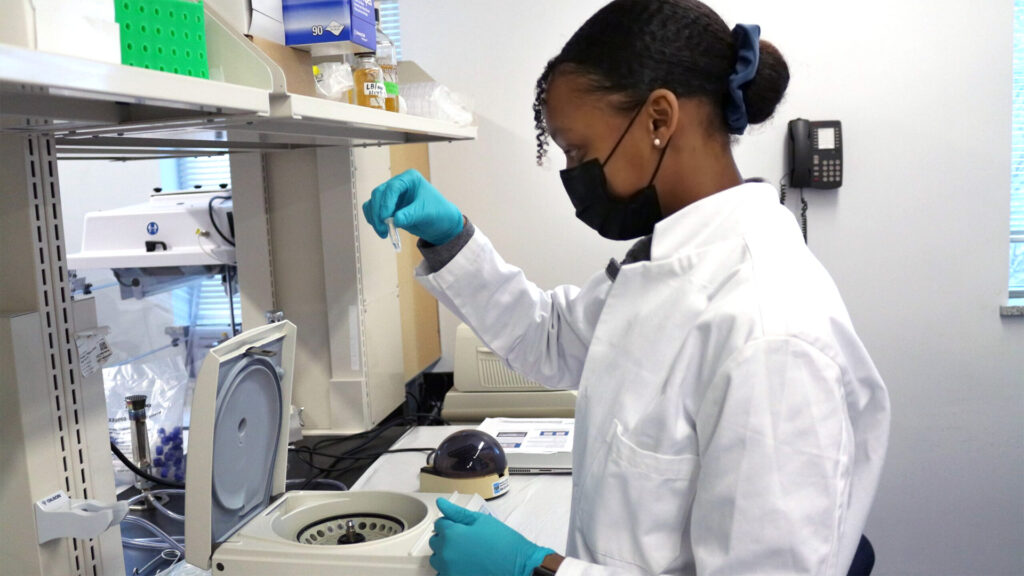 Student looking at centrifuge equipment