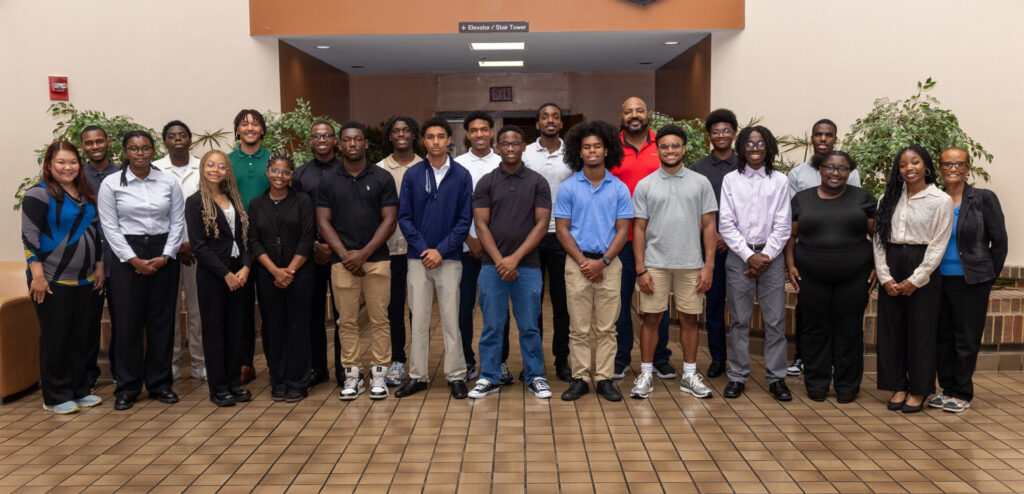 A large group of students pose shoulder to shoulder for the camera.