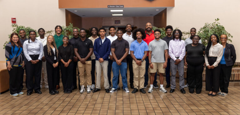 A large group of students pose shoulder to shoulder for the camera.
