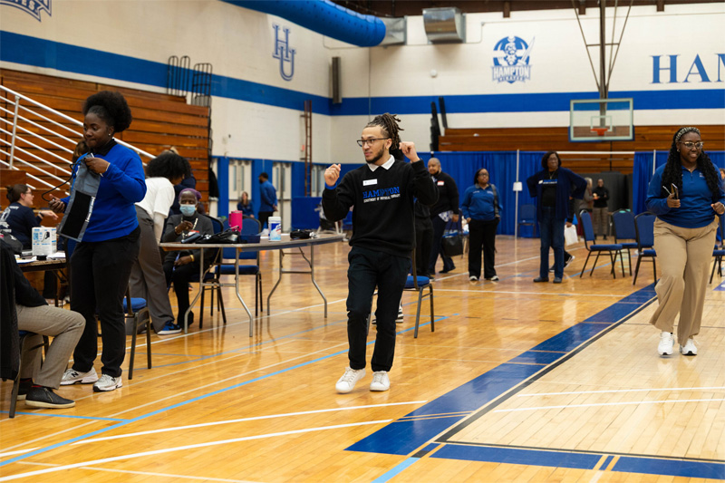 A student dances for senior attendees.