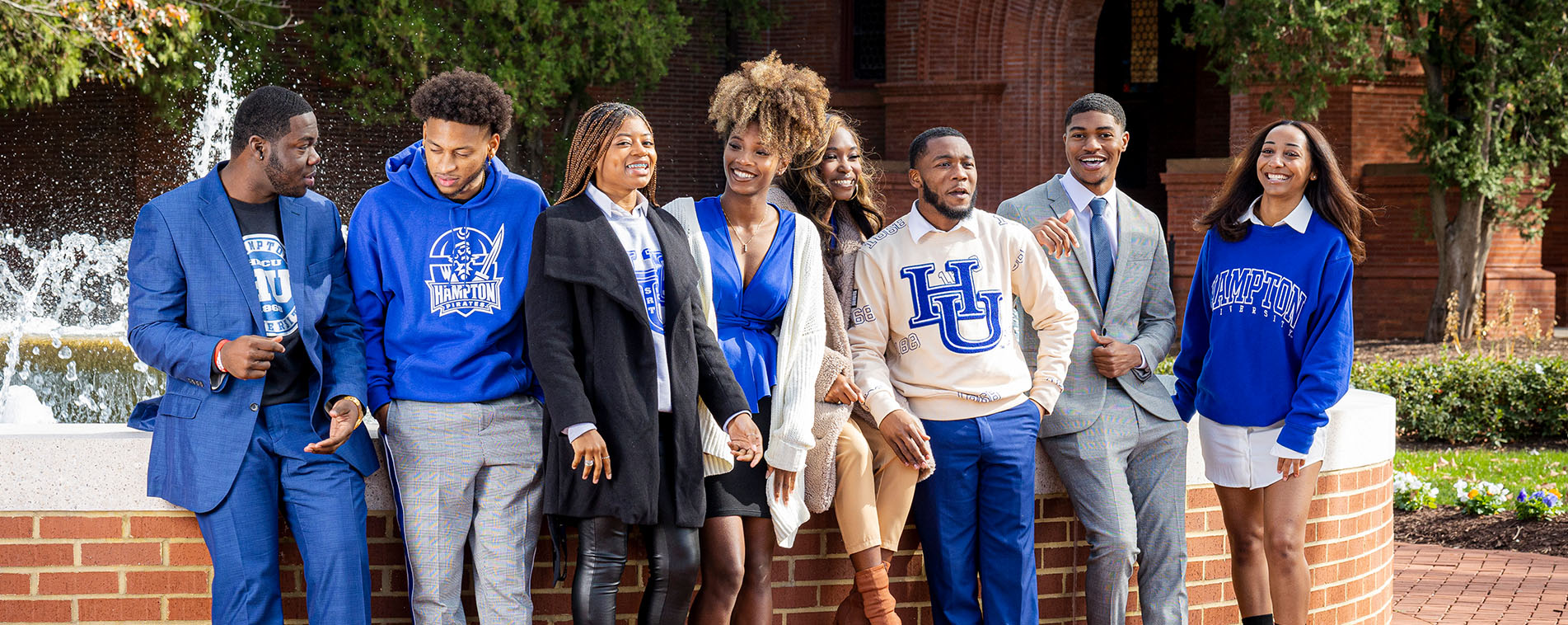 Students wearing HU memorabilia chat amongst themselves as they leave against the fountain in Legacy Park.